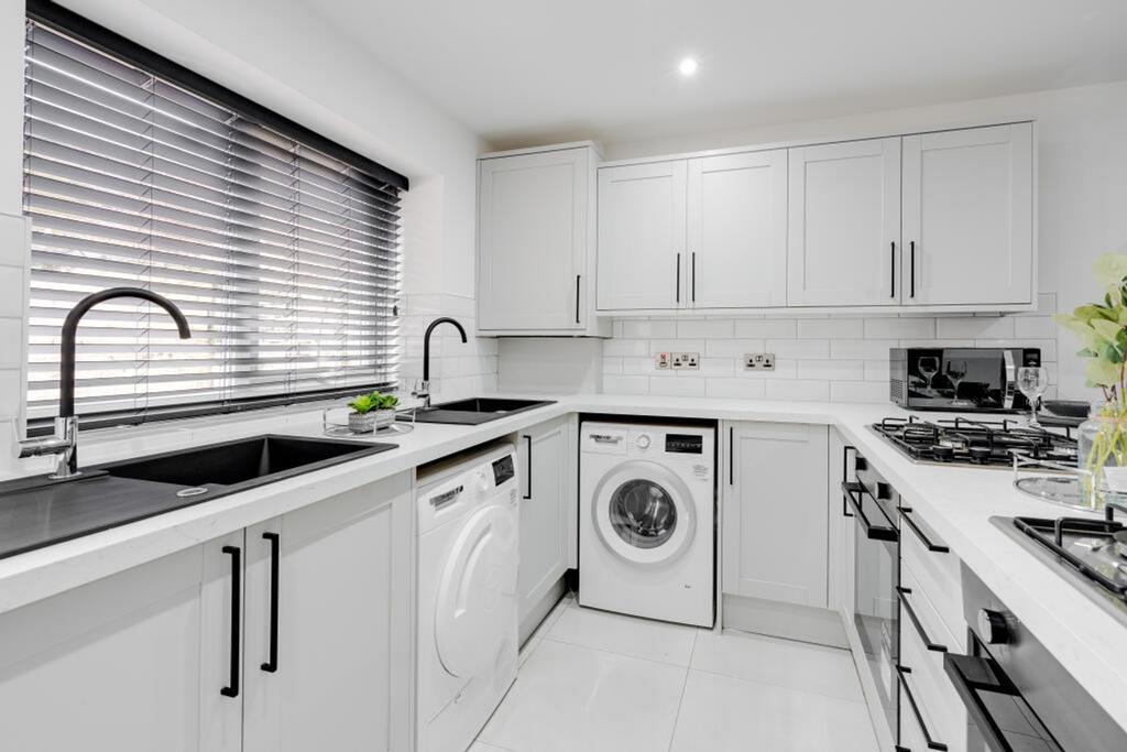 A modern, well-equipped kitchen featuring sleek...