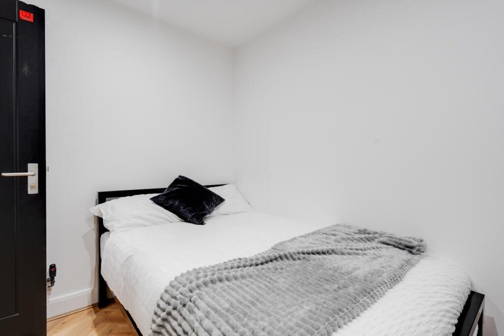 Cozy double bedroom featuring a comfortable bed...