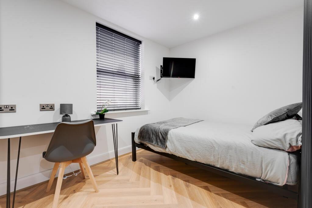 This stylish double bedroom features a comforta...