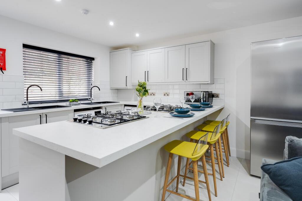 A modern and stylish kitchen featuring sleek ca...