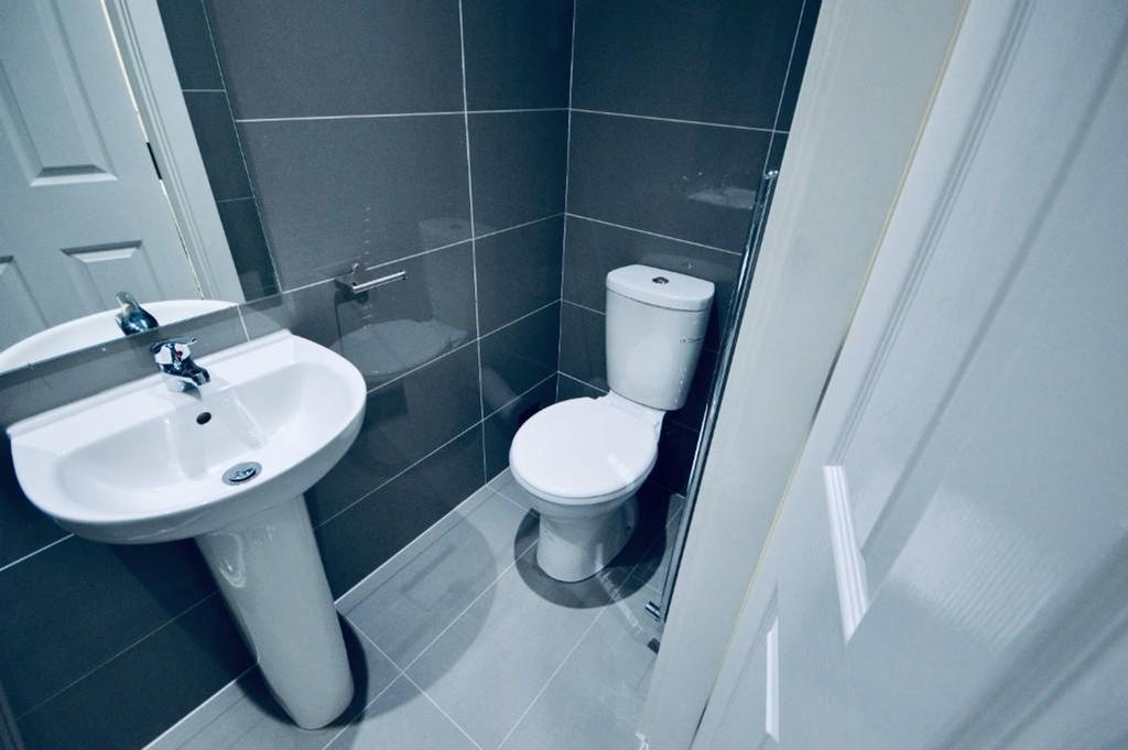 A modern and tidy bathroom featuring sleek fixt...