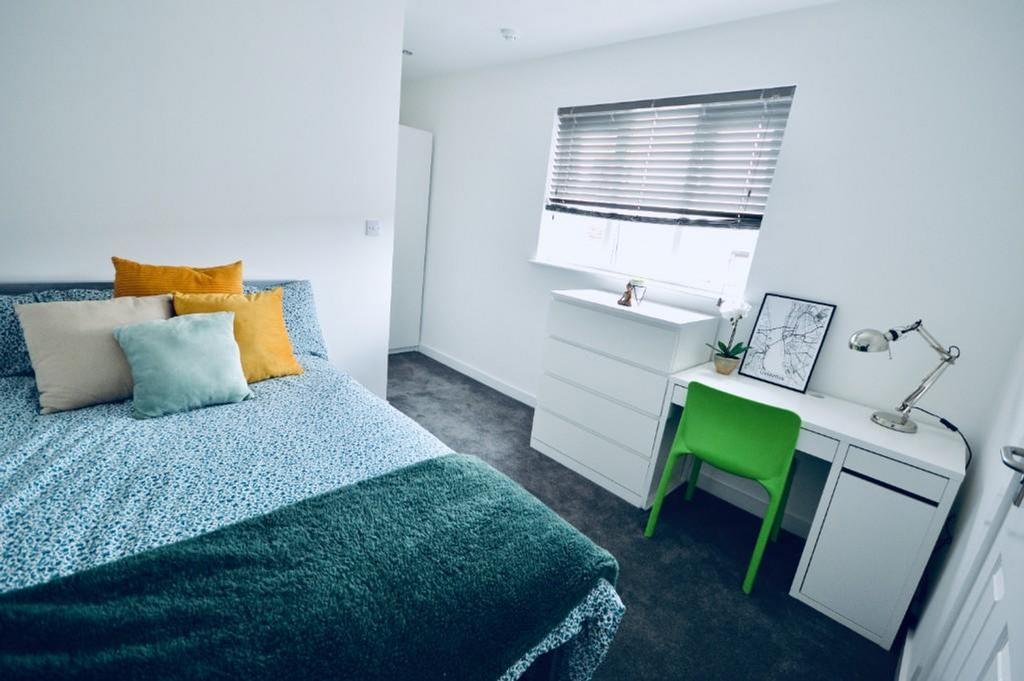 A bright and inviting double bedroom featuring ...