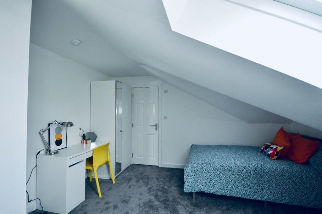 A bright and tidy double bedroom featuring a co...