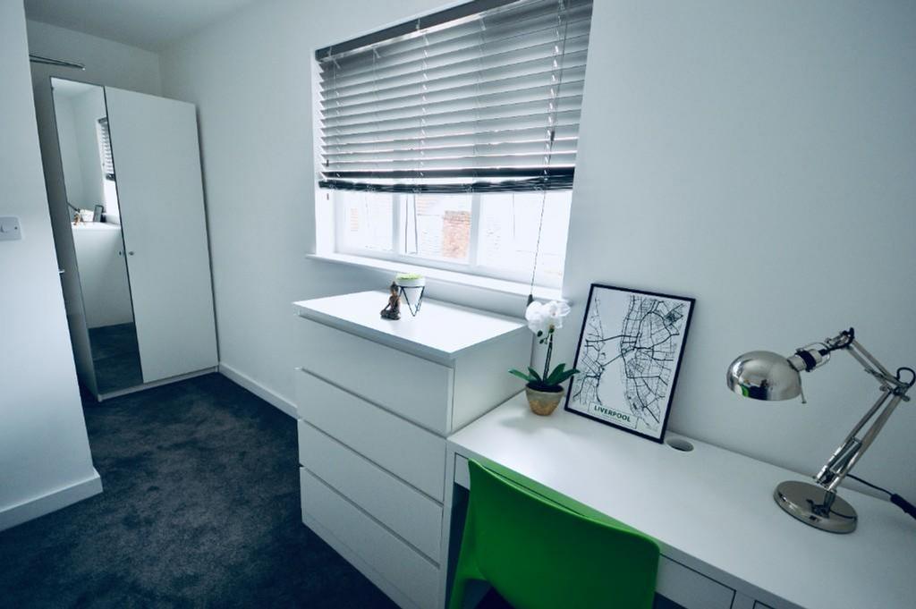 A bright and tidy double bedroom featuring a st...