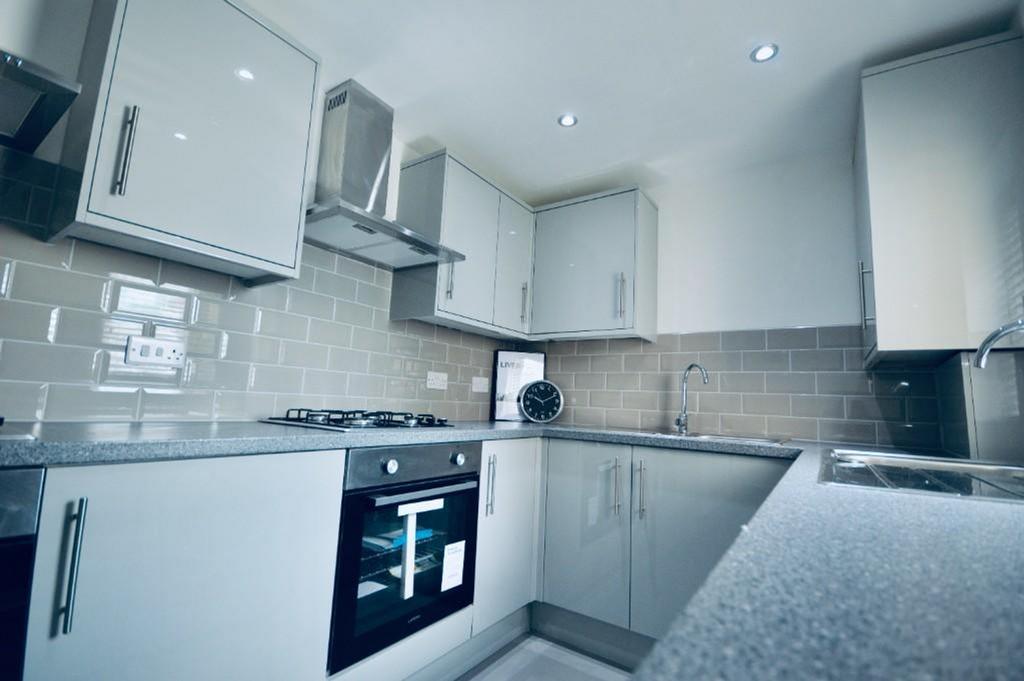 A modern and tidy kitchenette with sleek finish...