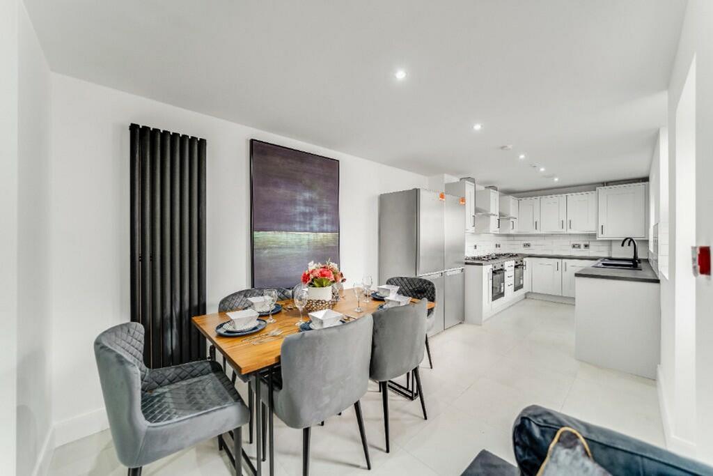 Bright and modern kitchen featuring sleek cabin...