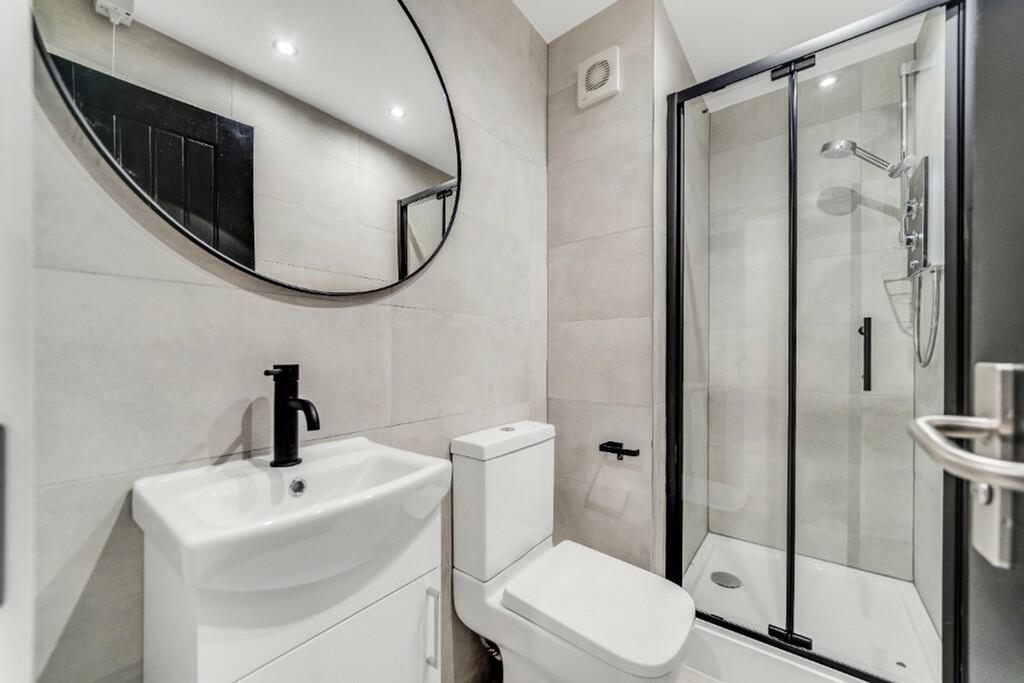 A stylish and modern bathroom featuring a sleek...