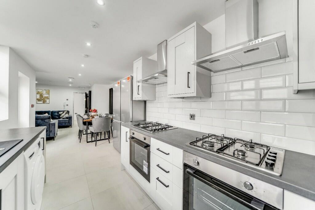 This modern kitchen features sleek cabinetry an...