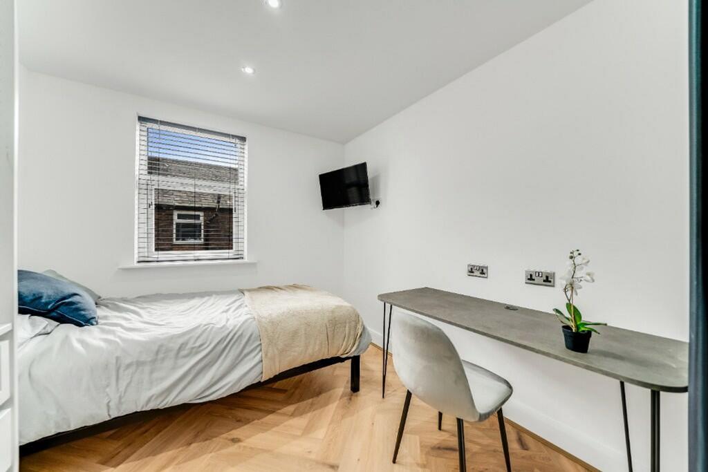 A modern double bedroom featuring a comfortable...