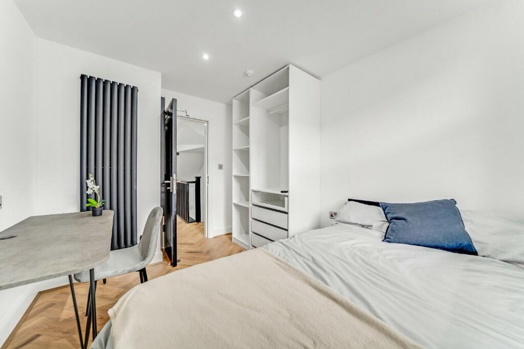 Bright and modern double bedroom featuring a co...