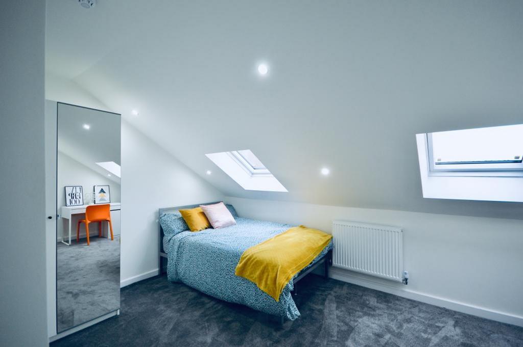 A bright and inviting double bedroom with moder...