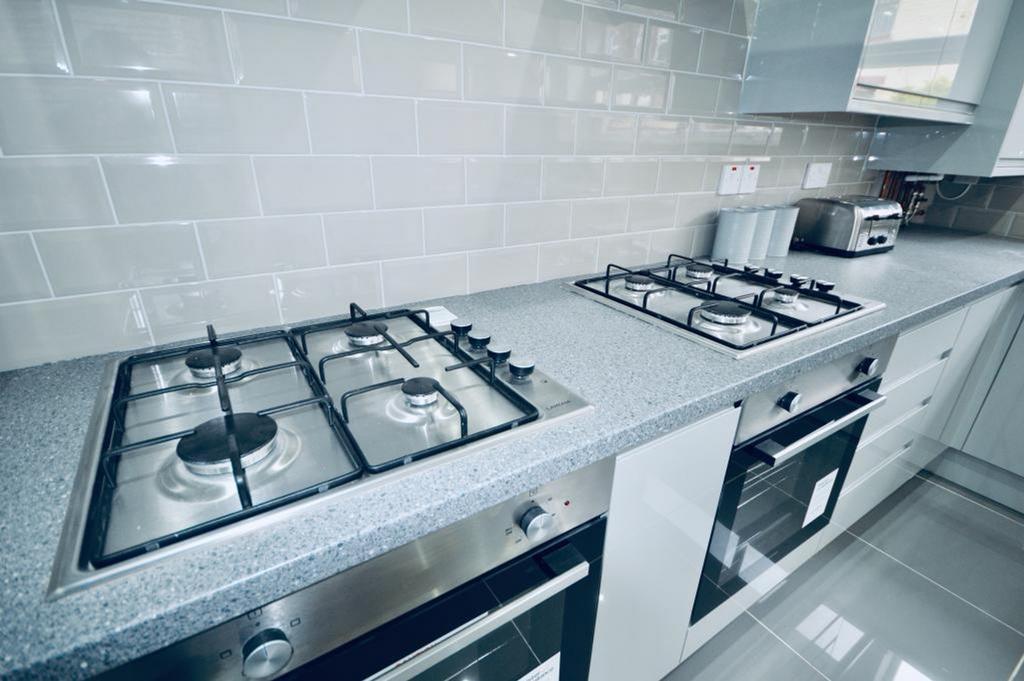 A modern and clean kitchen featuring sleek appl...
