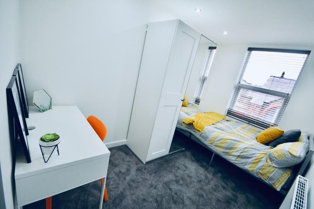 A bright and tidy double bedroom featuring a co...