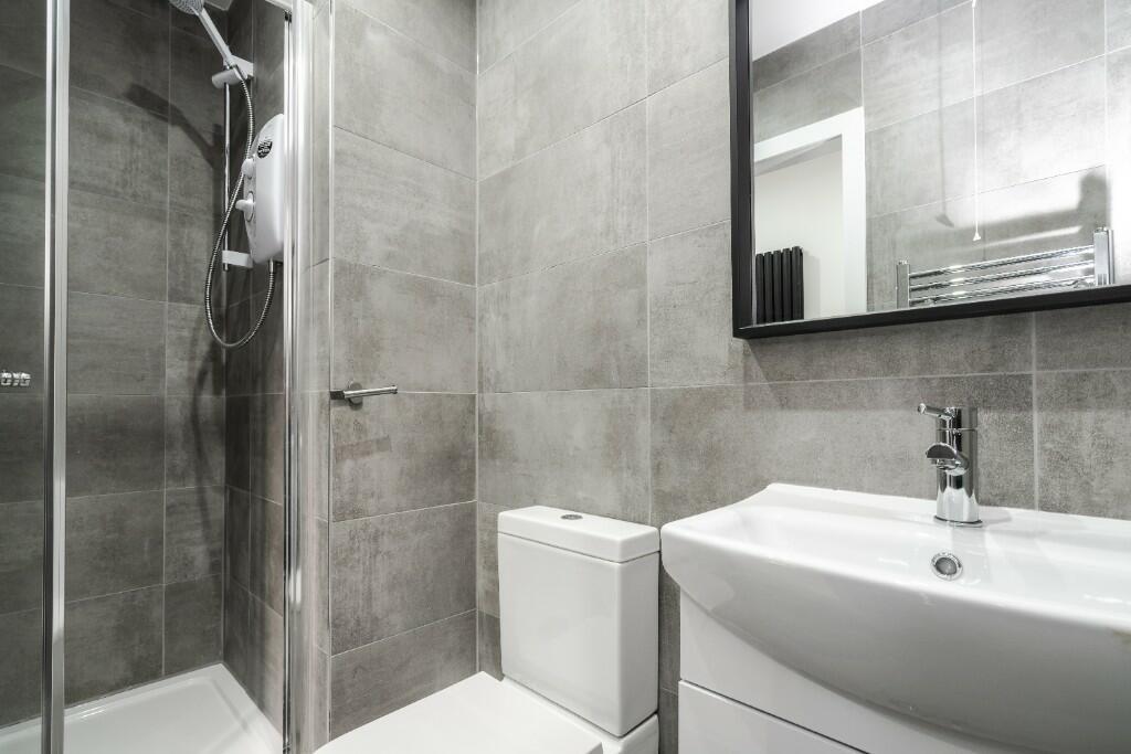 This modern bathroom features a sleek design wi...