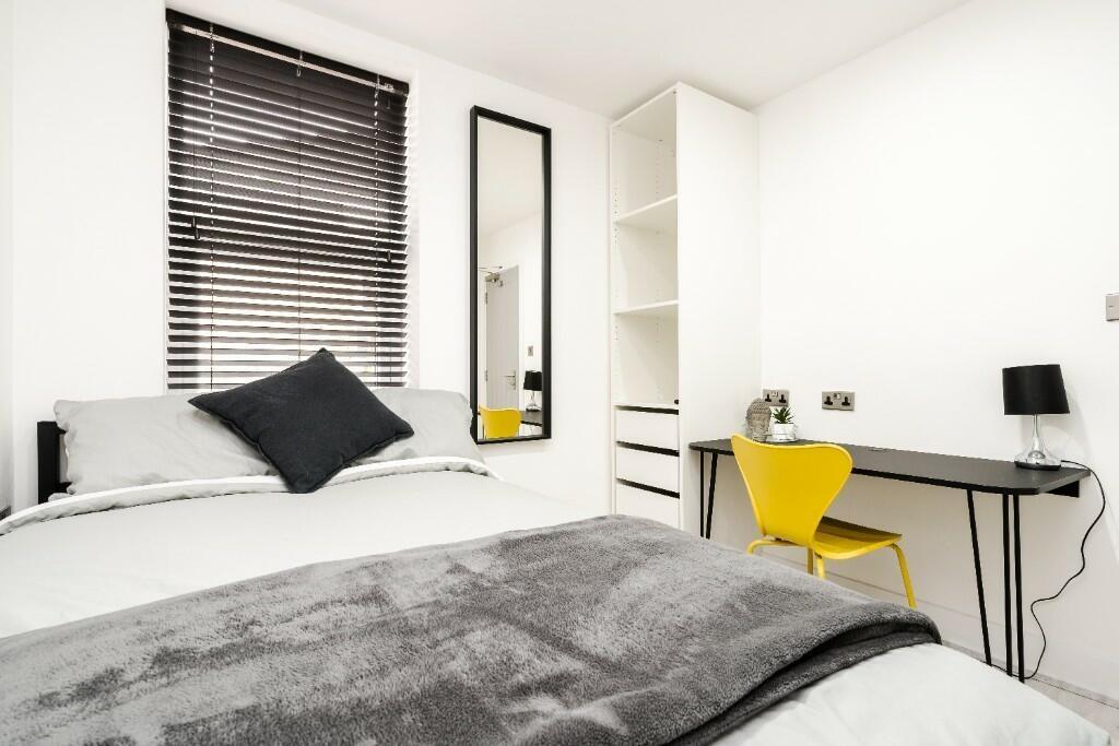Bright and inviting double bedroom featuring st...