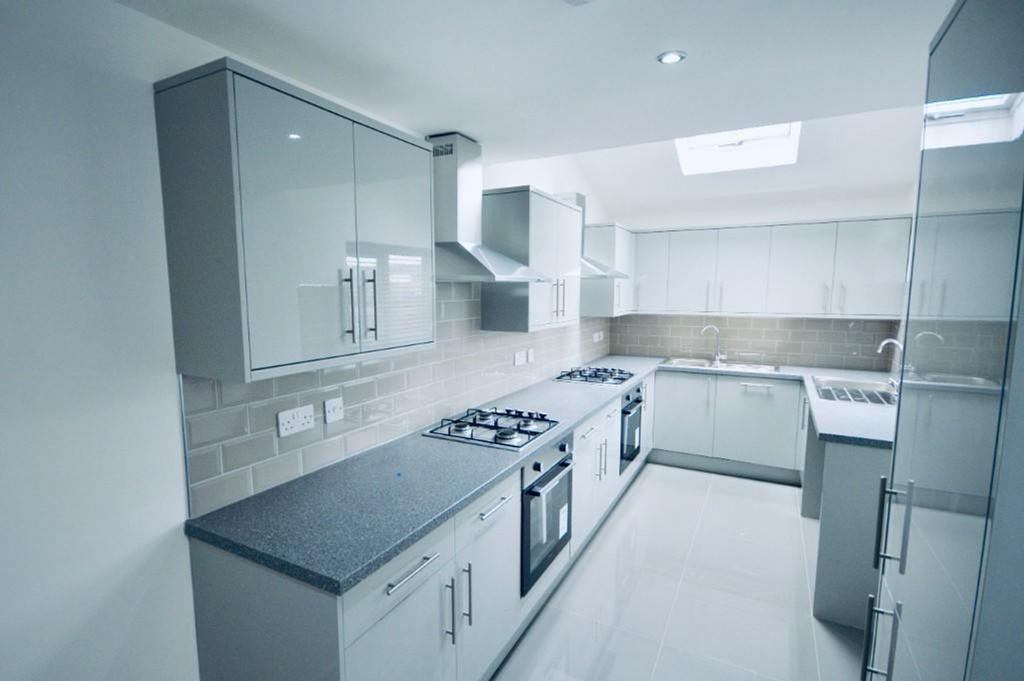 A modern and spacious kitchenette with ample st...