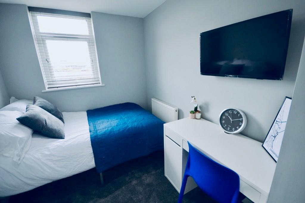 A bright and tidy double bedroom featuring a co...