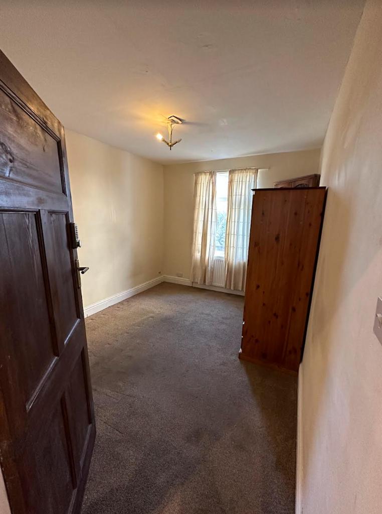 A cozy and inviting double bedroom with natural...