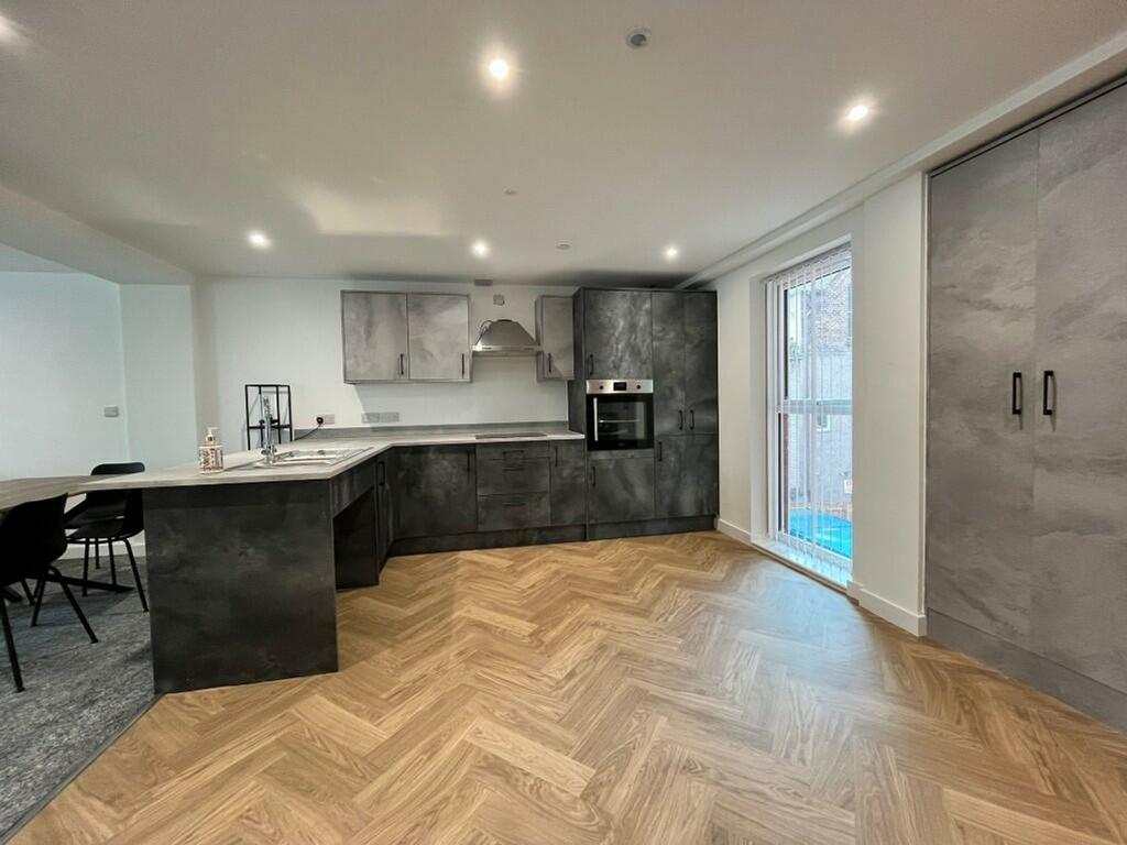 A modern and spacious kitchen featuring sleek c...