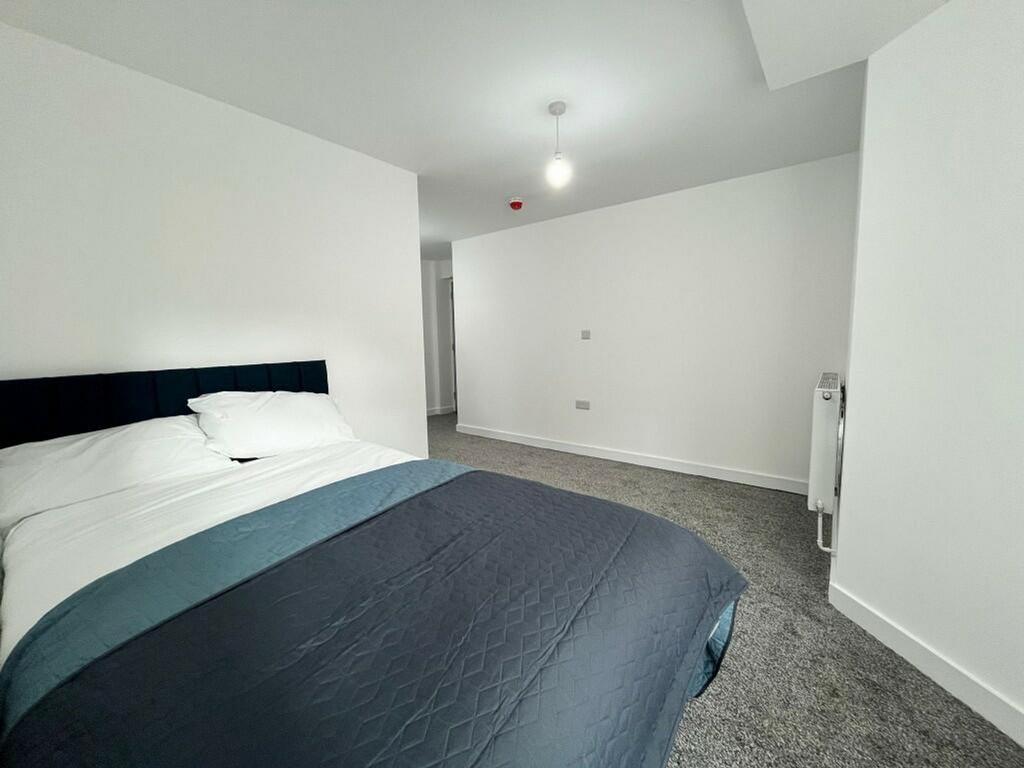 A spacious and inviting double bedroom with mod...