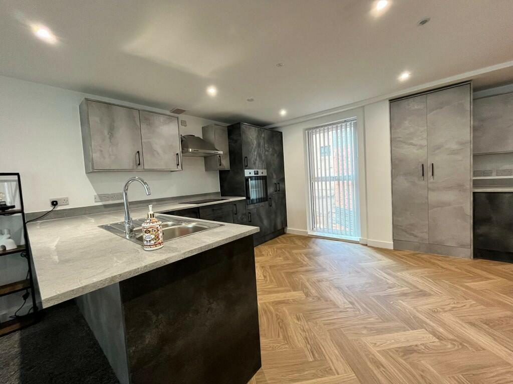 A modern and spacious kitchen featuring sleek c...