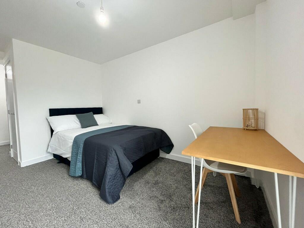A bright and inviting double bedroom featuring ...
