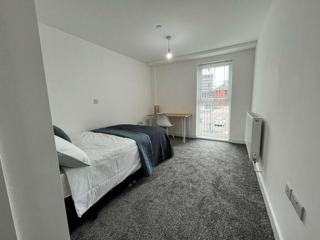 A bright and spacious double bedroom featuring ...