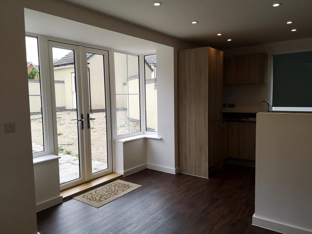 A modern and well-lit kitchen with ample space ...