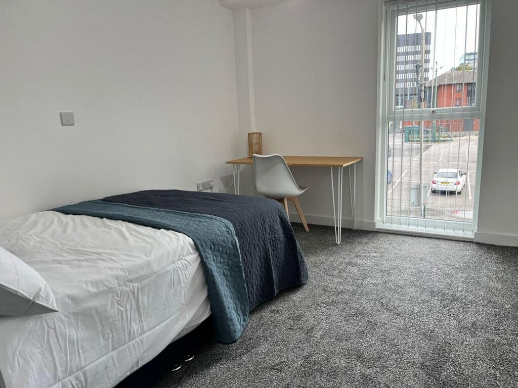 A bright and inviting double bedroom featuring ...