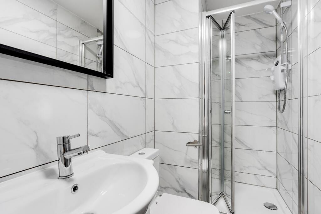A modern and pristine bathroom with stylish fin...