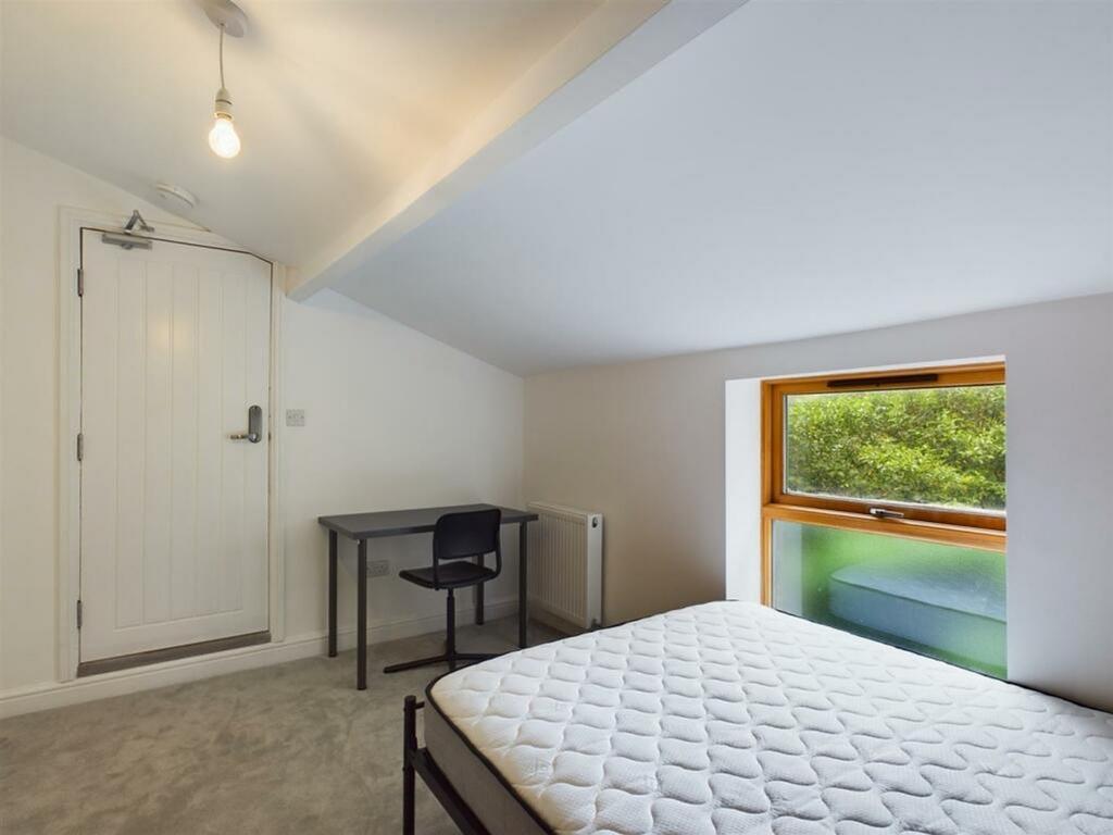 A bright and inviting double bedroom featuring ...