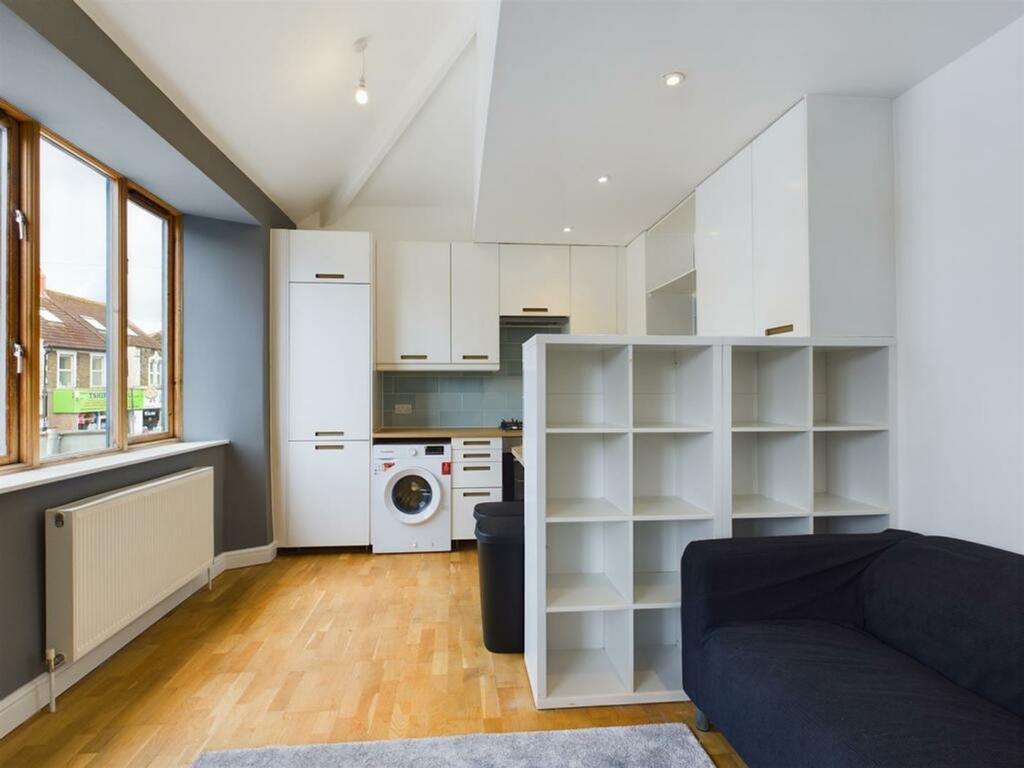 A bright and modern kitchenette with ample stor...