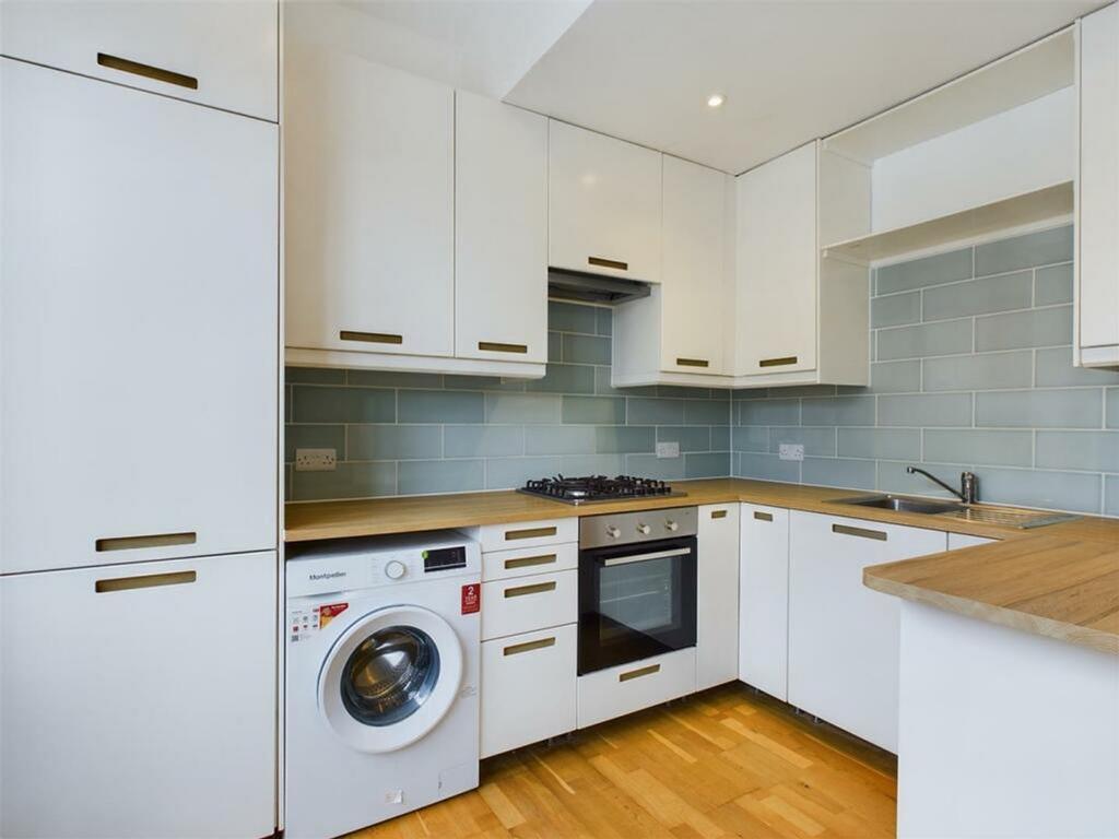 A modern and tidy kitchenette featuring sleek c...