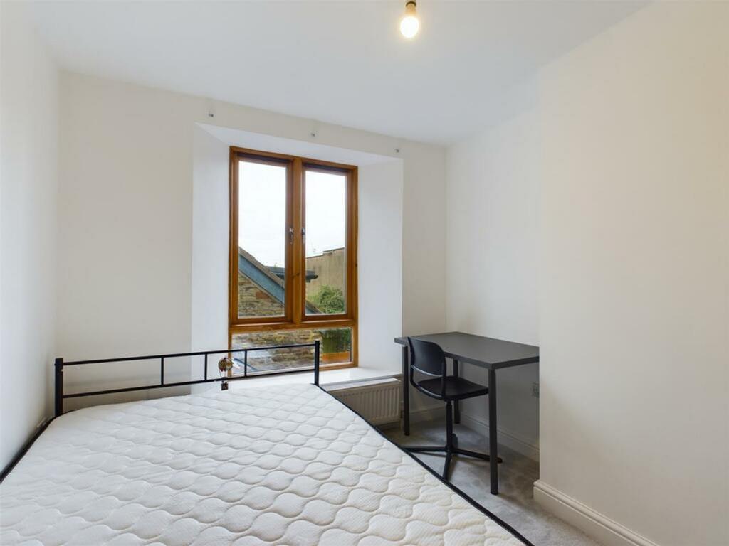 A bright and inviting double bedroom featuring ...