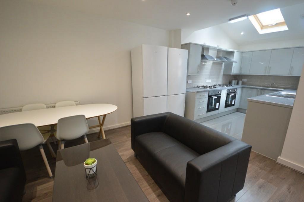 Modern kitchen featuring sleek cabinetry, ample...