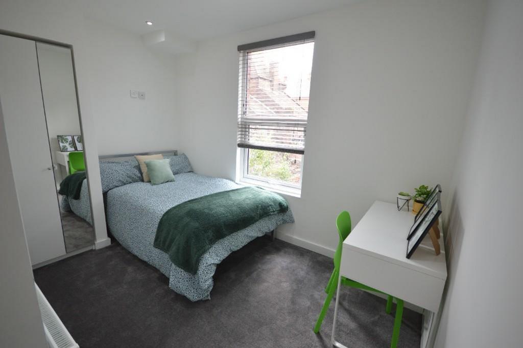 This inviting double bedroom features a comfort...