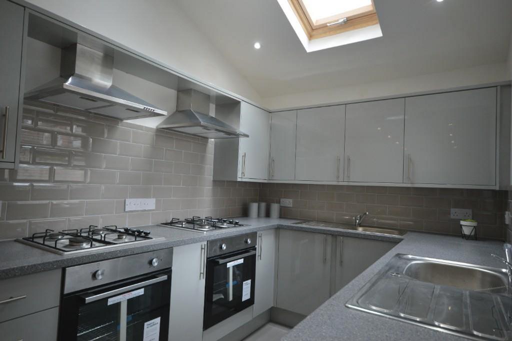 A modern kitchen featuring sleek cabinetry and ...