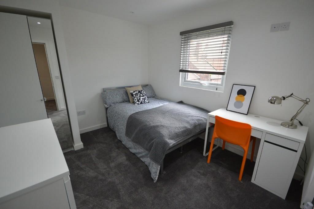 A cozy double bedroom featuring a comfortable d...