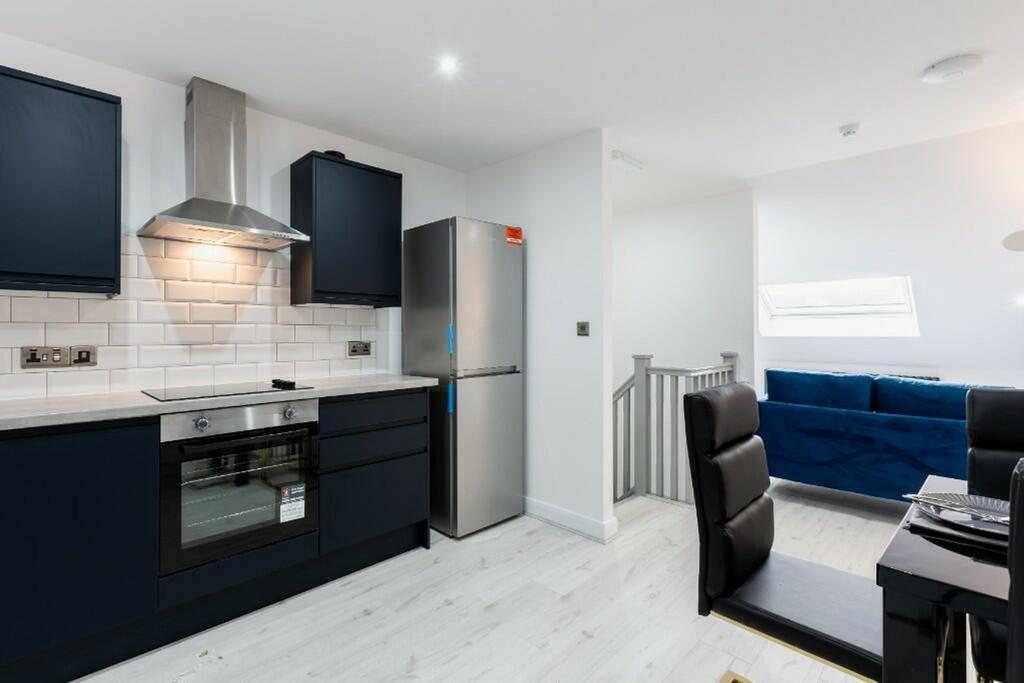 This modern kitchen features sleek cabinetry an...