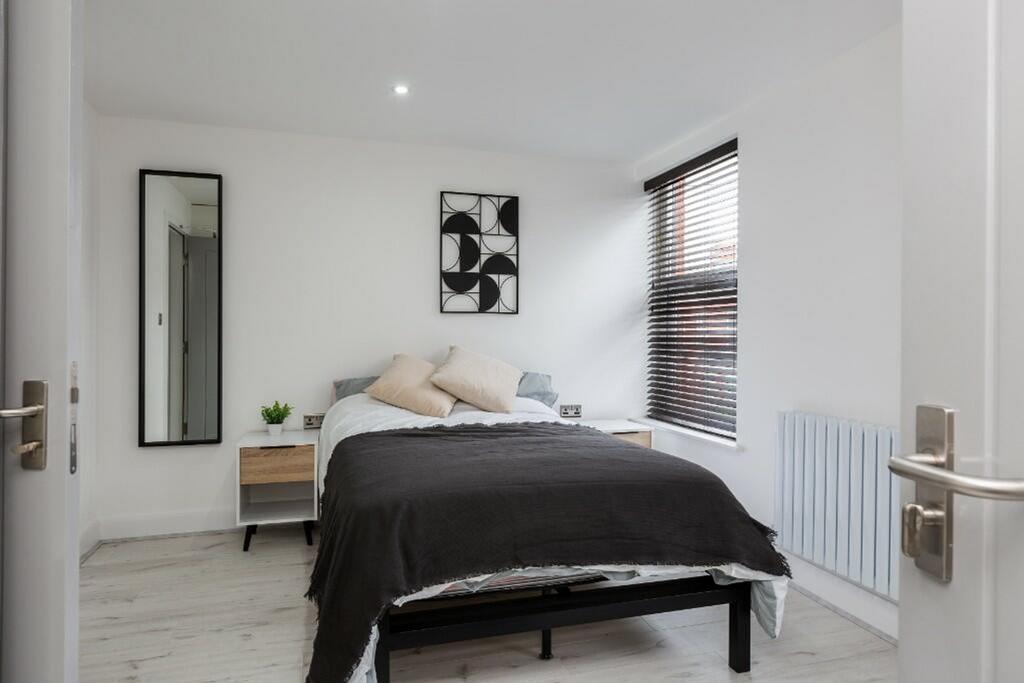 This modern double bedroom features a cozy atmo...