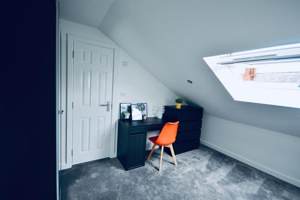 This inviting double bedroom features a cozy st...