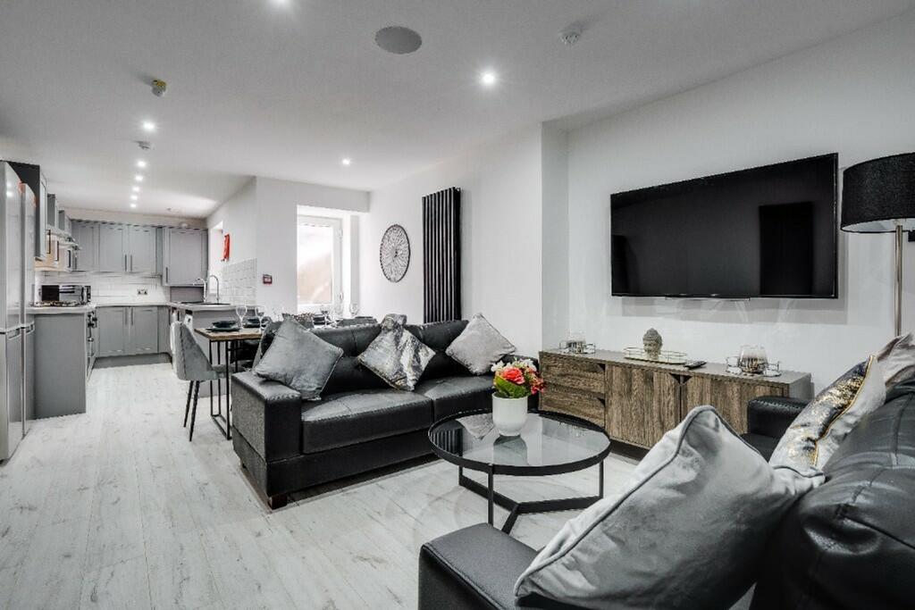 This contemporary living room features a spacio...
