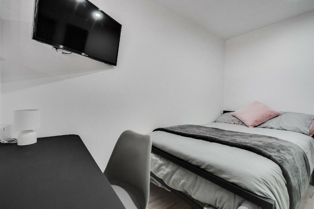 Cozy double bedroom featuring a comfortable bed...