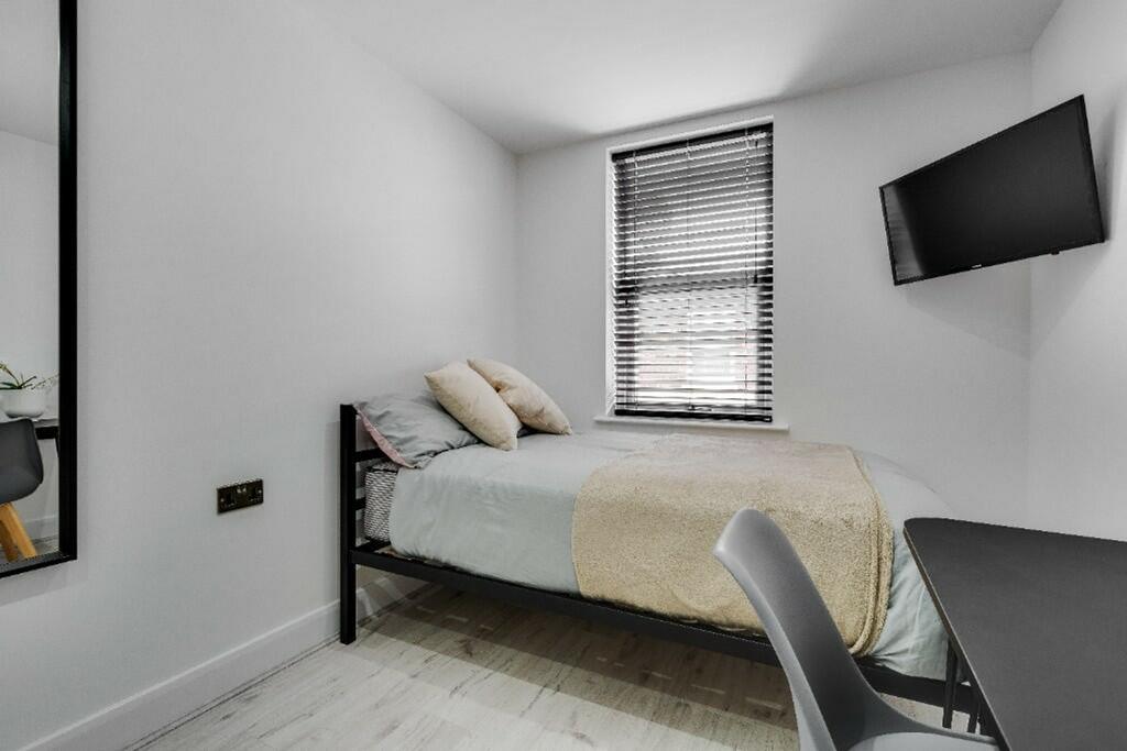 A stylish double bedroom featuring a comfortabl...
