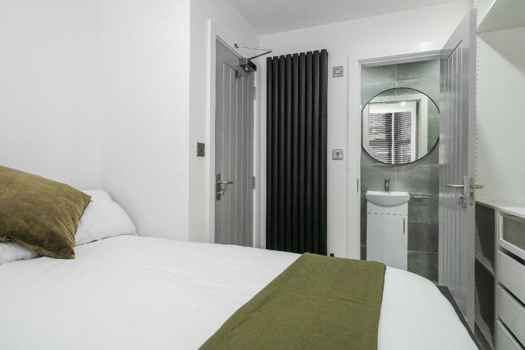 A stylish double bedroom featuring a comfortabl...