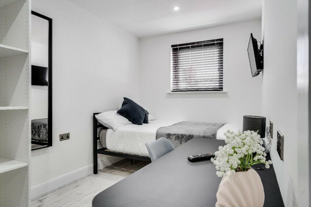 A stylish double bedroom featuring a comfortabl...