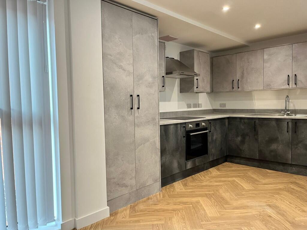 A modern and stylish kitchenette featuring slee...