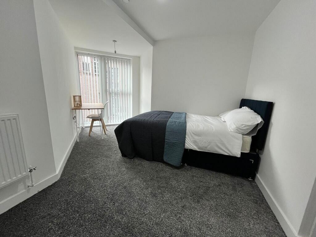 A bright and spacious double bedroom featuring ...