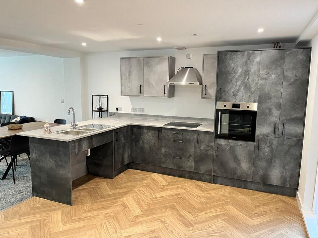A modern and stylish kitchen with ample space a...