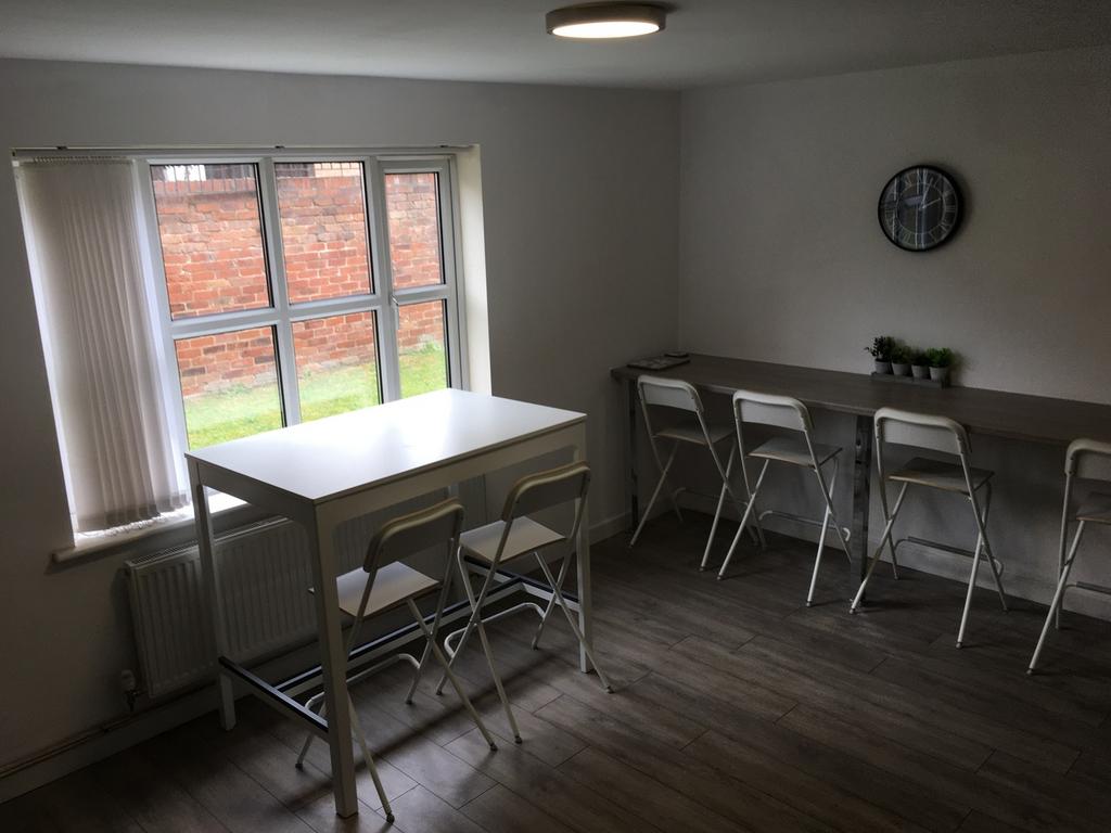 A bright and spacious living room with ample na...